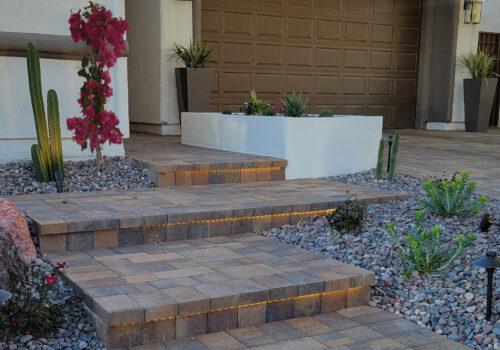 A home with a driveway and steps leading to the garage.