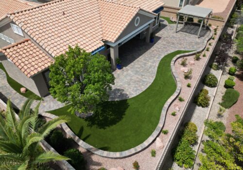 A bird 's eye view of a backyard with a lawn.