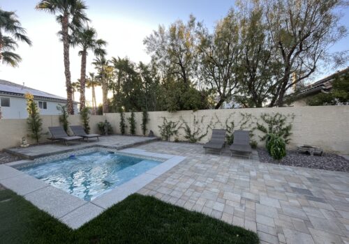 A pool that is in the middle of some grass.