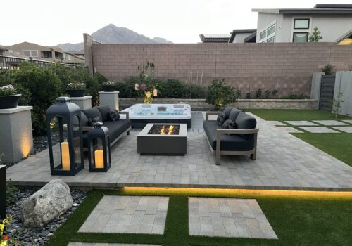 A patio with fire pit and couch set