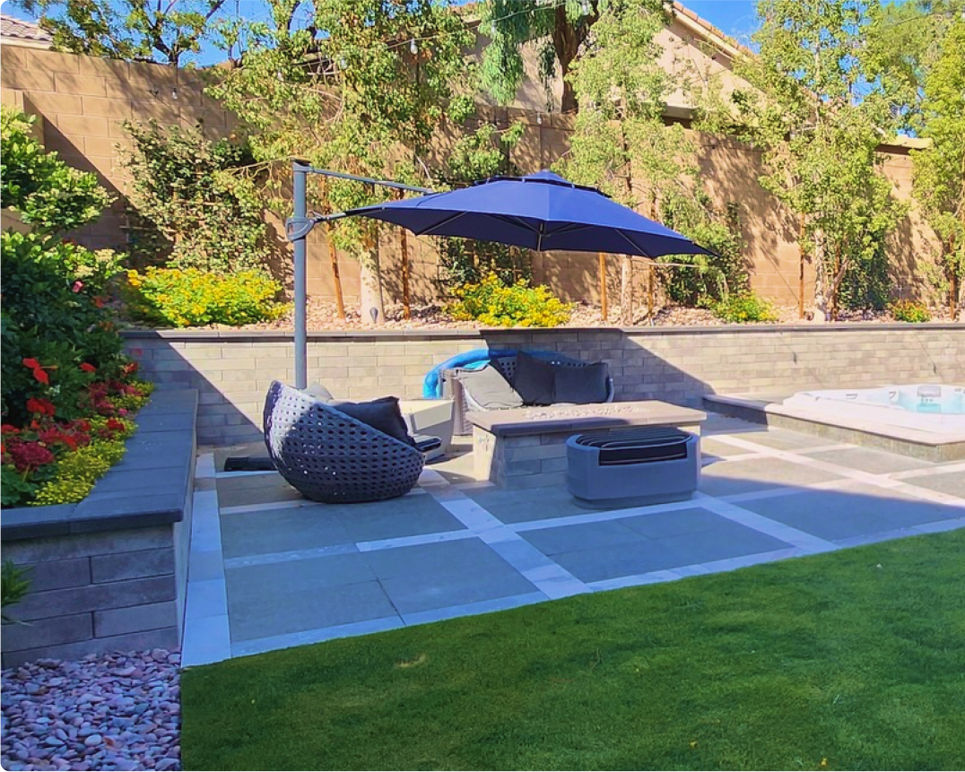 A patio with an umbrella and chairs in it