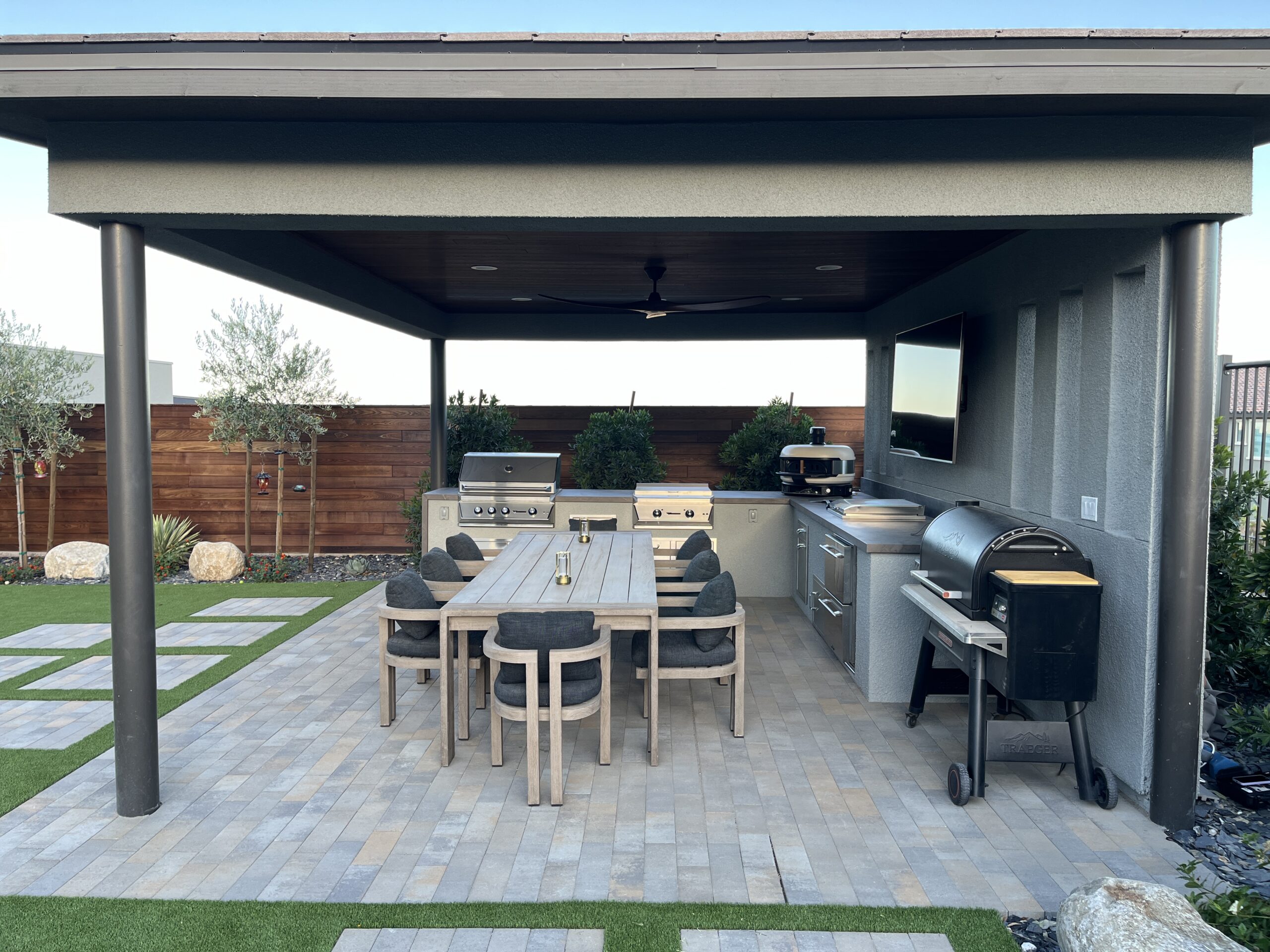 A patio with an outdoor grill and table A patio with an outdoor grill and table