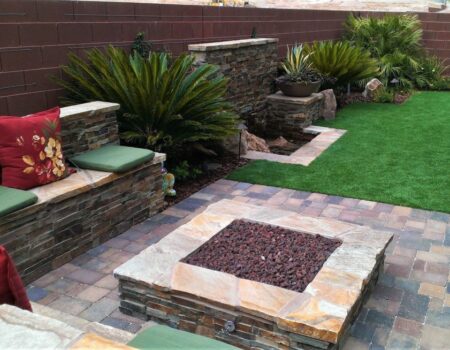 A fire pit sitting in the middle of a patio.